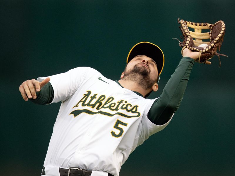 May 24, 2024; Oakland, California, USA; Oakland Athletics first baseman J.D. Davis (5) makes the catch of a foul popup off the bat of Houston Astros shortstop Jeremy Pena during the second inning at Oakland-Alameda County Coliseum. Mandatory Credit: D. Ross Cameron-USA TODAY Sports