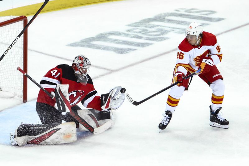 Feb 8, 2024; Newark, New Jersey, USA; New Jersey Devils goaltender Vitek Vanecek (41) makes a save against Calgary Flames left wing Andrei Kuzmenko (96) during the third period at Prudential Center. Mandatory Credit: John Jones-USA TODAY Sports