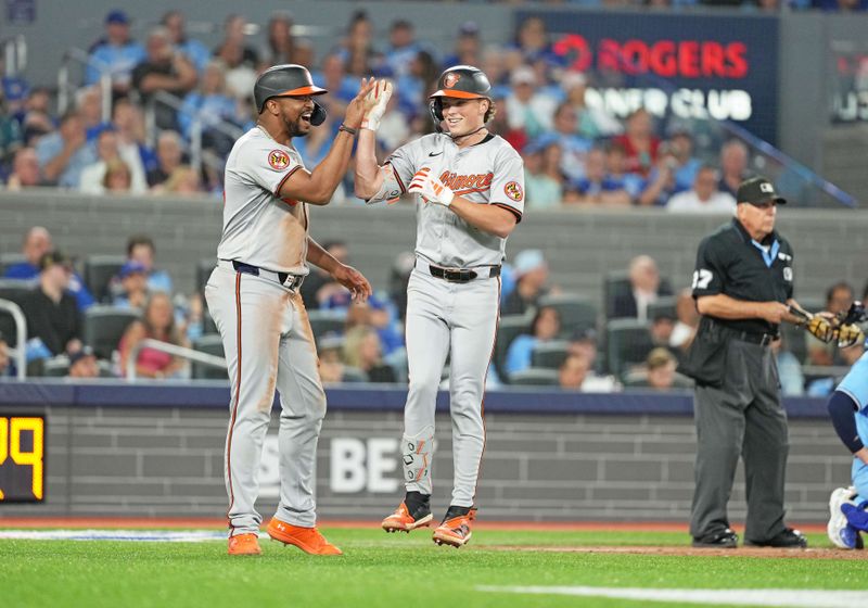 Aug 7, 2024; Toronto, Ontario, CAN; Baltimore Orioles second baseman Jackson Holliday (7) hits a two run home run and celebrates with designated hitter Eloy Jimenez (72) against the Toronto Blue Jays during the seventh inning at Rogers Centre. Mandatory Credit: Nick Turchiaro-USA TODAY Sports