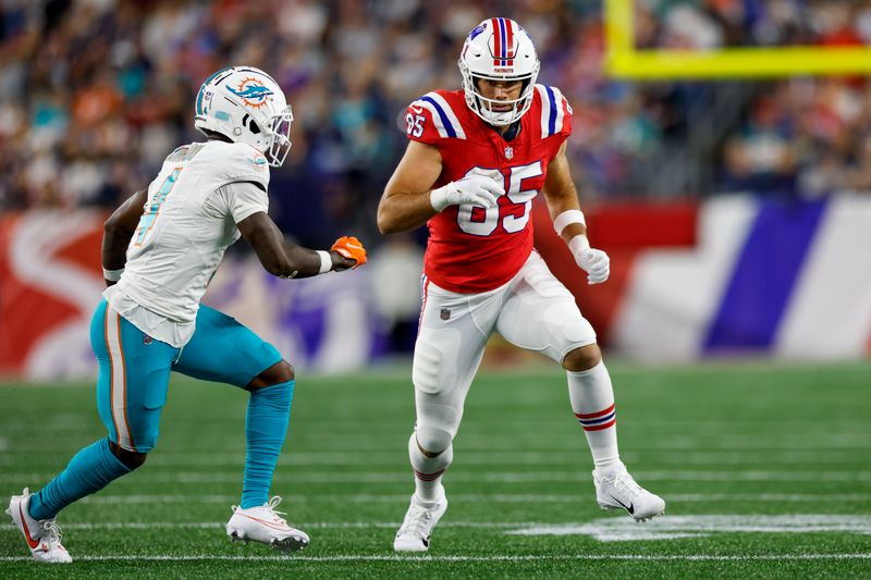 New England Patriots tight end Hunter Henry (85) runs a route against Miami Dolphins cornerback Kader Kohou (4) during the second half of an NFL football game on Sunday, Sept. 17, 2023, in Foxborough, Mass. (AP Photo/Greg M. Cooper)