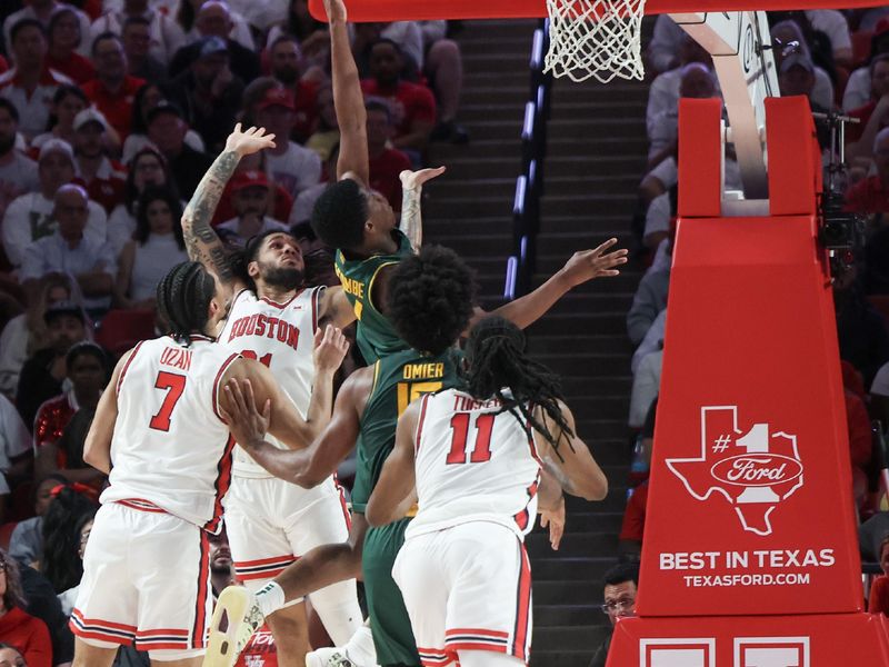 Feb 10, 2025; Houston, Texas, USA; Houston Cougars guard Milos Uzan (7) shoots against Houston Cougars guard Emanuel Sharp (21) in the first half at Fertitta Center. Mandatory Credit: Thomas Shea-Imagn Images