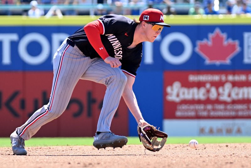 Mar 11, 2025; Dunedin, Florida, USA; Minnesota Twins shortstop Brandon Winokur (11) fields a ground ball in the second inning  against the Toronto Blue Jays during spring training  at TD Ballpark. Mandatory Credit: Jonathan Dyer-Imagn Images