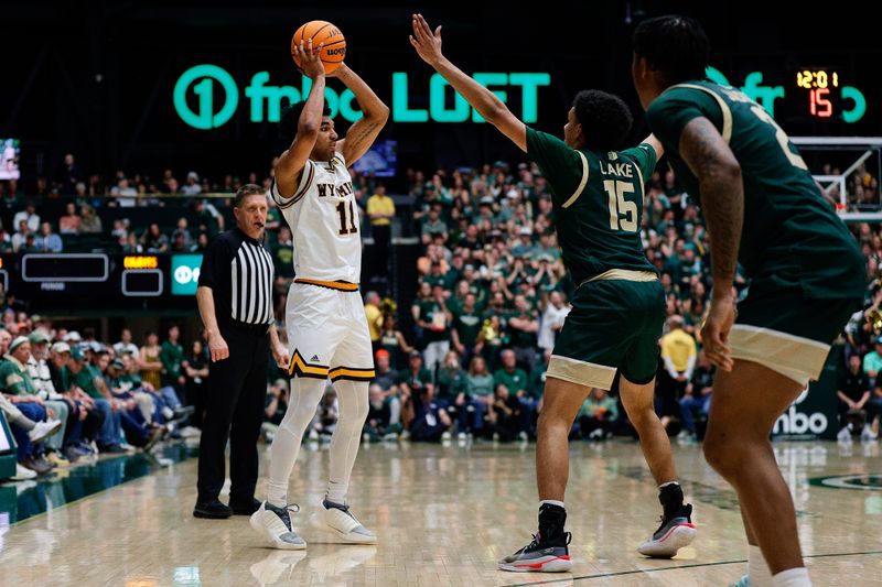 Mar 2, 2024; Fort Collins, Colorado, USA; Wyoming Cowboys guard Kael Combs (11) controls the ball as Colorado State Rams guard Jalen Lake (15) guards in the second half at Moby Arena. Mandatory Credit: Isaiah J. Downing-USA TODAY Sports