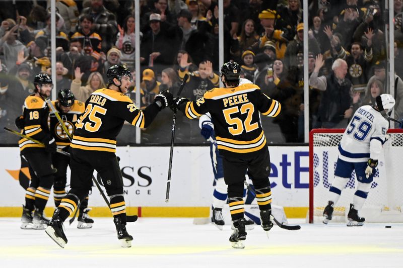 Jan 14, 2025; Boston, Massachusetts, USA; Boston Bruins defenseman Brandon Carlo (25) and defenseman Andrew Peeke (52) react after a goal was scored by right wing David Pastrnak (88) against the Tampa Bay Lightning during the second period at the TD Garden. Mandatory Credit: Brian Fluharty-Imagn Images