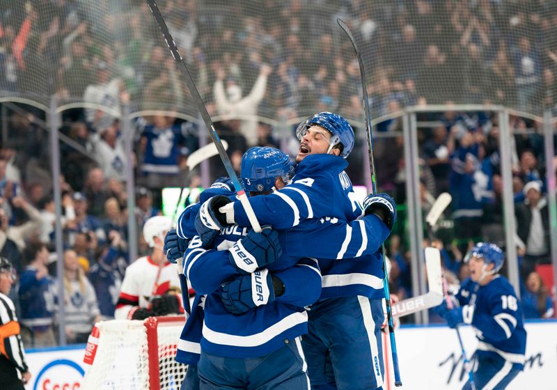 Oct 15, 2022; Toronto, Ontario, CAN; Toronto Maple Leafs defenseman Justin Holl (3) celebrates scoring a goal with Toronto Maple Leafs center Auston Matthews (34) against the Ottawa Senators during the third period at Scotiabank Arena. Mandatory Credit: Nick Turchiaro-USA TODAY Sports