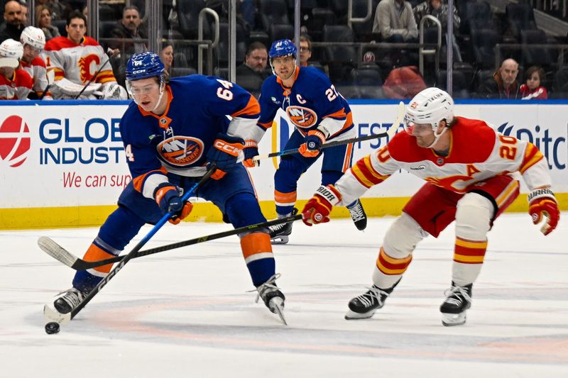 Mar 14, 2026; Elmont, New York, USA;  New York Islanders center Calum Ritchie (64) skates with the puck defended by Calgary Flames left wing Blake Coleman (20) during the second period at UBS Arena. Mandatory Credit: Dennis Schneidler-Imagn Images