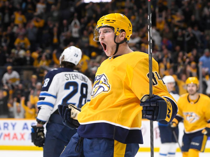 Jan 24, 2023; Nashville, Tennessee, USA;  Nashville Predators left wing Tanner Jeannot (84) celebrates the go ahead goal against the Winnipeg Jets during the third period at Bridgestone Arena. Mandatory Credit: Steve Roberts-USA TODAY Sports