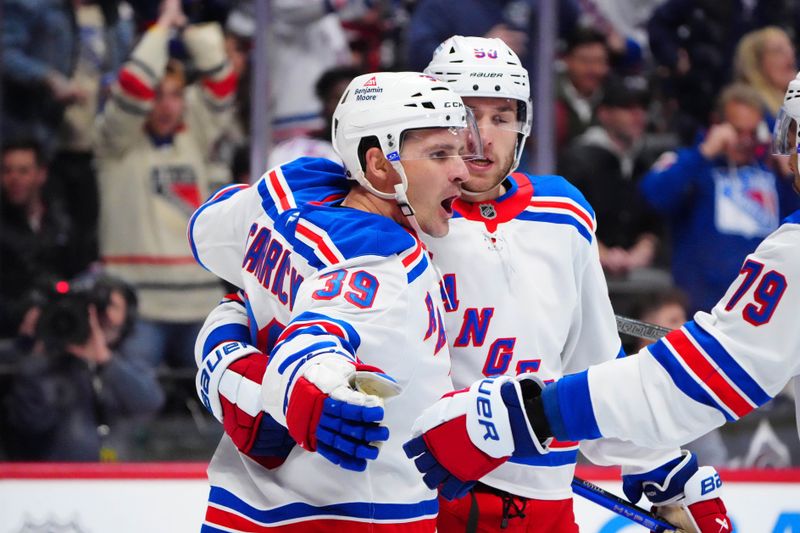 Jan 14, 2025; Denver, Colorado, USA; New York Rangers center Sam Carrick (39) celebrates his short handed goal with left wing Will Cuylle (50) and defenseman K'Andre Miller (79) in the first period against the Colorado Avalanche at Ball Arena. Mandatory Credit: Ron Chenoy-Imagn Images