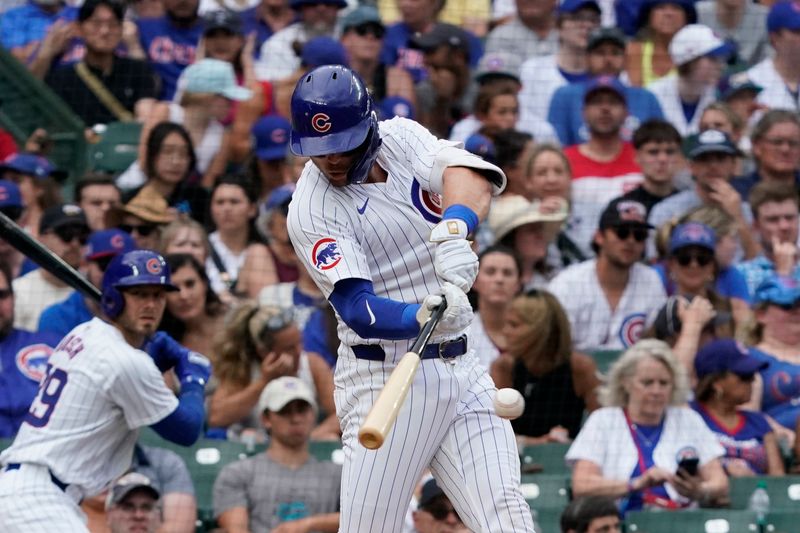 Jul 7, 2024; Chicago, Illinois, USA; Chicago Cubs second baseman Nico Hoerner (2)  hits a single against the Los Angeles Angels during the fifth inning at Wrigley Field. Mandatory Credit: David Banks-USA TODAY Sports