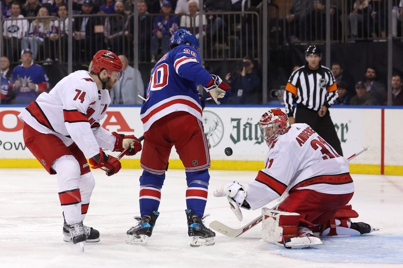 May 13, 2024; New York, New York, USA; Carolina Hurricanes goaltender Frederik Andersen (31) plays the puck against New York Rangers left wing Chris Kreider (20) during the second period of game five of the second round of the 2024 Stanley Cup Playoffs at Madison Square Garden. Mandatory Credit: Brad Penner-USA TODAY Sports