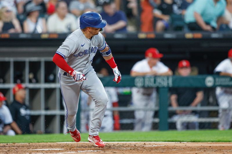 Jul 4, 2023; Chicago, Illinois, USA; Toronto Blue Jays second baseman Whit Merrifield (15) watches his two-run double against the Chicago White Sox during the fourth inning at Guaranteed Rate Field. Mandatory Credit: Kamil Krzaczynski-USA TODAY Sports