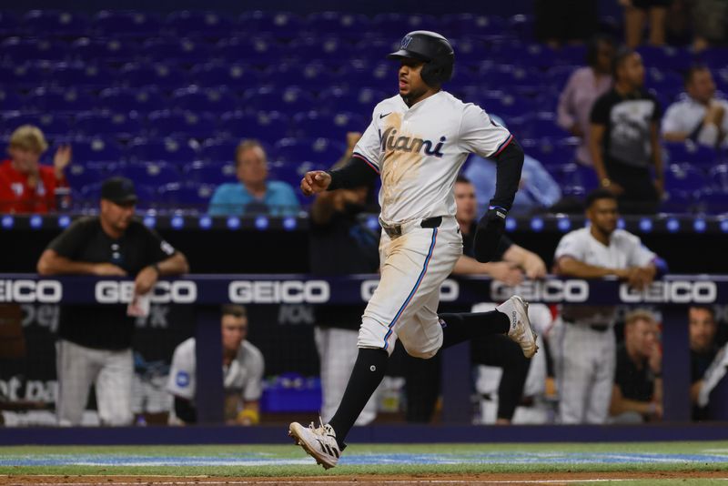 Sep 4, 2024; Miami, Florida, USA; Miami Marlins shortstop Xavier Edwards (63) scores after an RBI single by first baseman Jake Burger (not pictured) against the Washington Nationals during the eighth inning at loanDepot Park. Mandatory Credit: Sam Navarro-Imagn Images