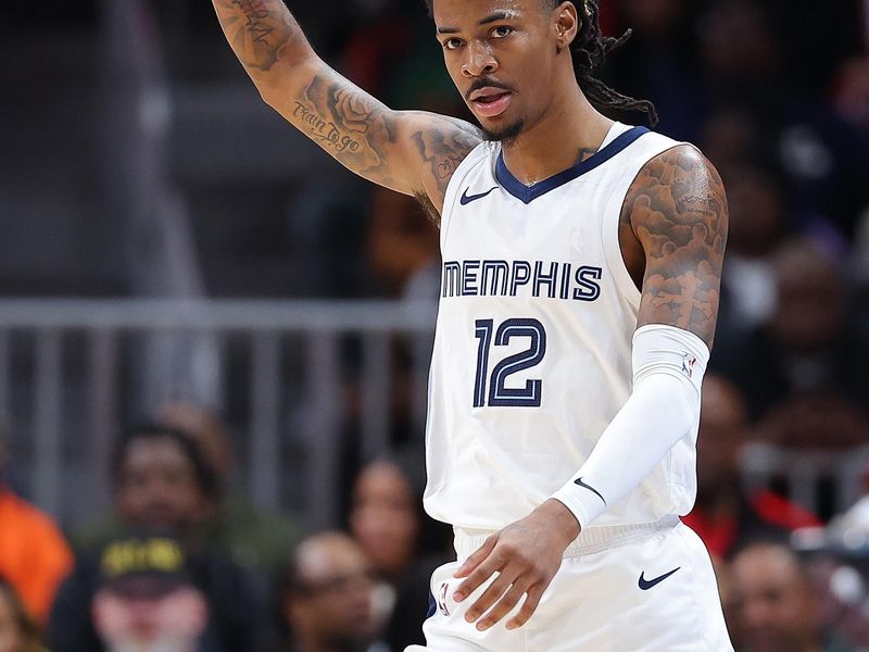 ATLANTA, GEORGIA - DECEMBER 23:  Ja Morant #12 of the Memphis Grizzlies reacts after drawing a foul and scoring a basket against the Atlanta Hawks during the second quarter at State Farm Arena on December 23, 2023 in Atlanta, Georgia.  NOTE TO USER: User expressly acknowledges and agrees that, by downloading and/or using this photograph, user is consenting to the terms and conditions of the Getty Images License Agreement. (Photo by Kevin C. Cox/Getty Images)