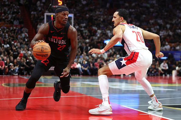 MIAMI, FLORIDA - NOVEMBER 03: Jimmy Butler #22 of the Miami Heat drives against Landry Shamet #20 of the Washington Wizards in the first quarter during the NBA In-Season Tournament at Kaseya Center on November 03, 2023 in Miami, Florida. NOTE TO USER: User expressly acknowledges and agrees that, by downloading and or using this photograph, User is consenting to the terms and conditions of the Getty Images License Agreement. (Photo by Megan Briggs/Getty Images)