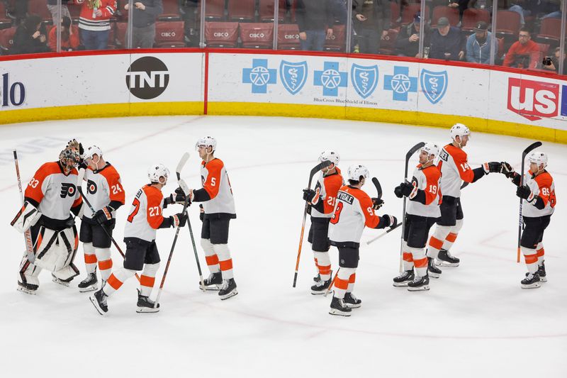 Feb 21, 2024; Chicago, Illinois, USA; Philadelphia Flyers players celebrate after defeating the Chicago Blackhawks at United Center. Mandatory Credit: Kamil Krzaczynski-USA TODAY Sports