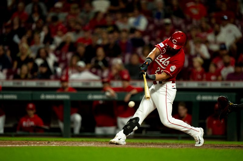 Sep 23, 2023; Cincinnati, Ohio, USA; Cincinnati Reds right fielder Nick Martini (23) hits a fielders choice RBI base hit in the eighth inning against the Pittsburgh Pirates at Great American Ball Park. Mandatory Credit: The Cincinnati Enquirer-USA TODAY Sports