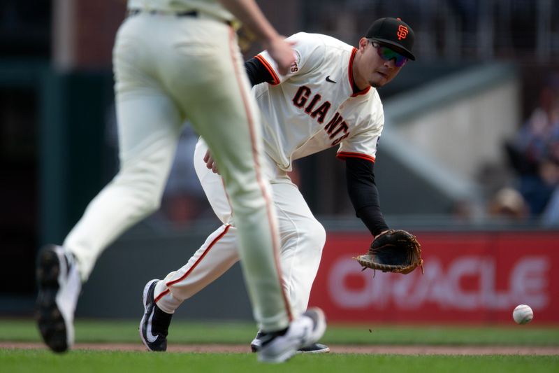 Sep 10, 2025; San Francisco, California, USA; San Francisco Giants first baseman Wilmer Flores (41) fields a ground ball by Arizona Diamondbacks left fielder Jake McCarthy during the eighth inning at Oracle Park. Mandatory Credit: D. Ross Cameron-Imagn Images