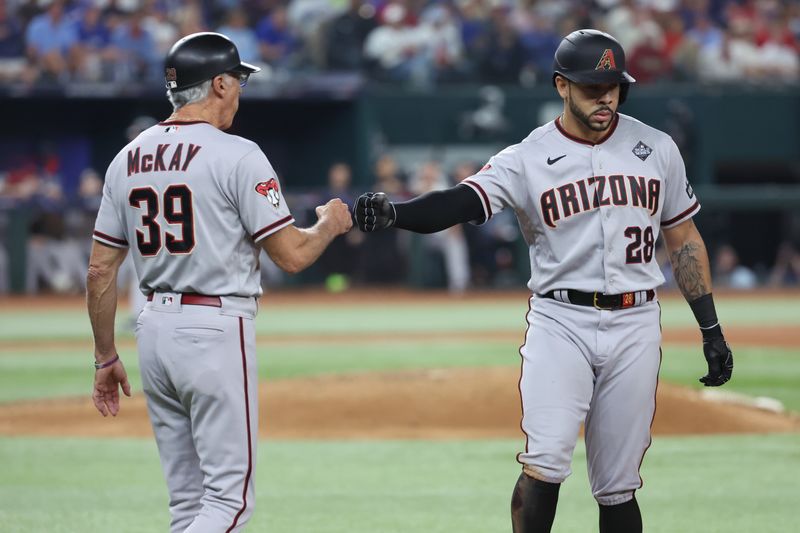 Oct 28, 2023; Arlington, TX, USA; Arizona Diamondbacks left fielder Tommy Pham (28) celebrates hitting a single with first base coach Dave McKay (39) against the Texas Rangers  in the eighth inning  in game two of the 2023 World Series at Globe Life Field. Mandatory Credit: Kevin Jairaj-USA TODAY Sports