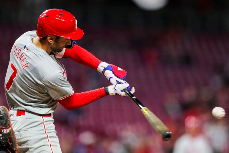 Apr 22, 2024; Cincinnati, Ohio, USA; Philadelphia Phillies shortstop Trea Turner (7) hits a single against the Cincinnati Reds in the ninth inning at Great American Ball Park. Mandatory Credit: Katie Stratman-USA TODAY Sports