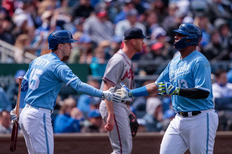 Apr 16, 2023; Kansas City, Missouri, USA; Kansas City Royals left fielder Edward Olivares (14) slaps hands with  third baseman Matt Duffy (15) after scoring during the sixth inning against the Atlanta Braves at Kauffman Stadium. Mandatory Credit: William Purnell-USA TODAY Sports