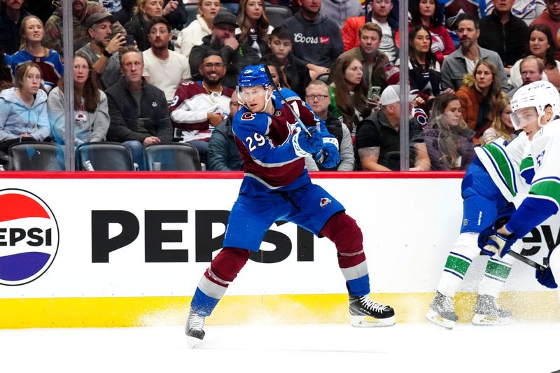 Nov 22, 2023; Denver, Colorado, USA; Colorado Avalanche center Nathan MacKinnon (29) shoots on net in the second period against the Vancouver Canucks at Ball Arena. Mandatory Credit: Ron Chenoy-USA TODAY Sports