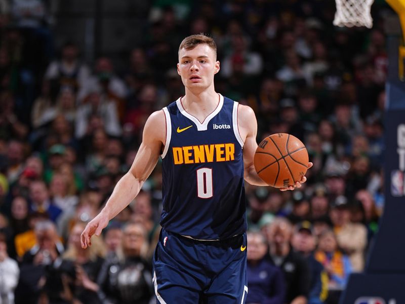 DENVER, CO - JANUARY 7: Christian Braun #0 of the Denver Nuggets dribbles the ball during the game against the Boston Celtics on January 7, 2025 at Ball Arena in Denver, Colorado. NOTE TO USER: User expressly acknowledges and agrees that, by downloading and/or using this Photograph, user is consenting to the terms and conditions of the Getty Images License Agreement. Mandatory Copyright Notice: Copyright 2025 NBAE (Photo by Garrett Ellwood/NBAE via Getty Images)