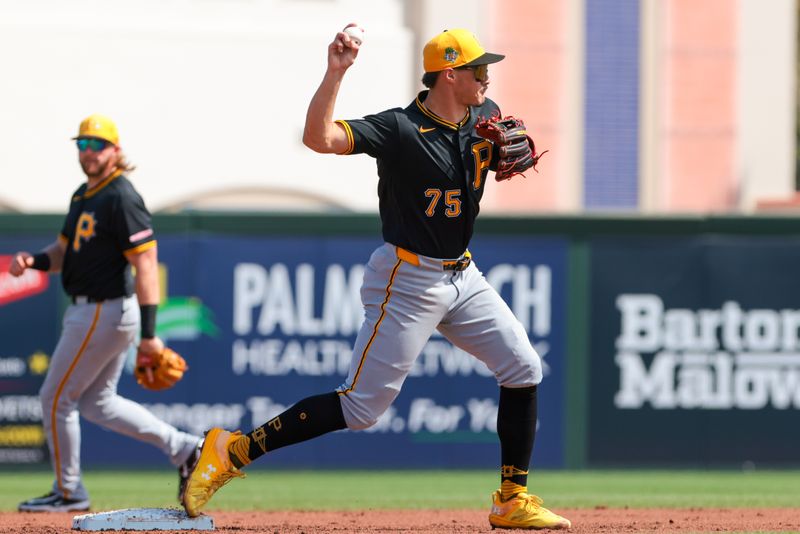 Mar 1, 2026; Jupiter, Florida, USA; Pittsburgh Pirates shortstop Konnor Griffin (75) turns a double play against the St. Louis Cardinals during the second inning at Roger Dean Chevrolet Stadium. Mandatory Credit: Sam Navarro-Imagn Images