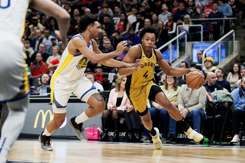 TORONTO, CANADA - MARCH 1: Scottie Barnes #4 of the Toronto Raptors dribbles against Trayce Jackson-Davis #32 of the Golden State Warriors in the first half of their NBA game at Scotiabank Arena on March 1, 2024 in Toronto, Canada.  NOTE TO USER: User expressly acknowledges and agrees that, by downloading and or using this photograph, User is consenting to the terms and conditions of the Getty Images License Agreement. (Photo by Cole Burston/Getty Images)