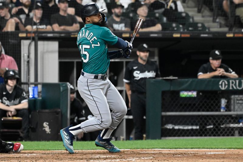 Aug 21, 2023; Chicago, Illinois, USA;  Seattle Mariners right fielder Teoscar Hernandez (35) hits a two RBI single against the Chicago White Sox during the sixth inning at Guaranteed Rate Field. Mandatory Credit: Matt Marton-USA TODAY Sports