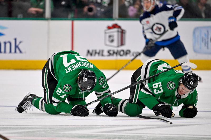 Dec 1, 2024; Dallas, Texas, USA; Dallas Stars left wing Mason Marchment (27) collides with teammate right wing Evgenii Dadonov (63) at center ice during the first period against the Winnipeg Jets at the American Airlines Center. Mandatory Credit: Jerome Miron-Imagn Images