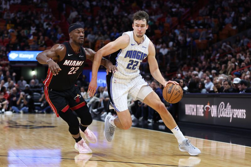 MIAMI, FLORIDA - FEBRUARY 06: Franz Wagner #22 of the Orlando Magic drives against Jimmy Butler #22 of the Miami Heat during the second quarter of the game at Kaseya Center on February 06, 2024 in Miami, Florida. NOTE TO USER: User expressly acknowledges and agrees that, by downloading and or using this photograph, User is consenting to the terms and conditions of the Getty Images License Agreement. (Photo by Megan Briggs/Getty Images)