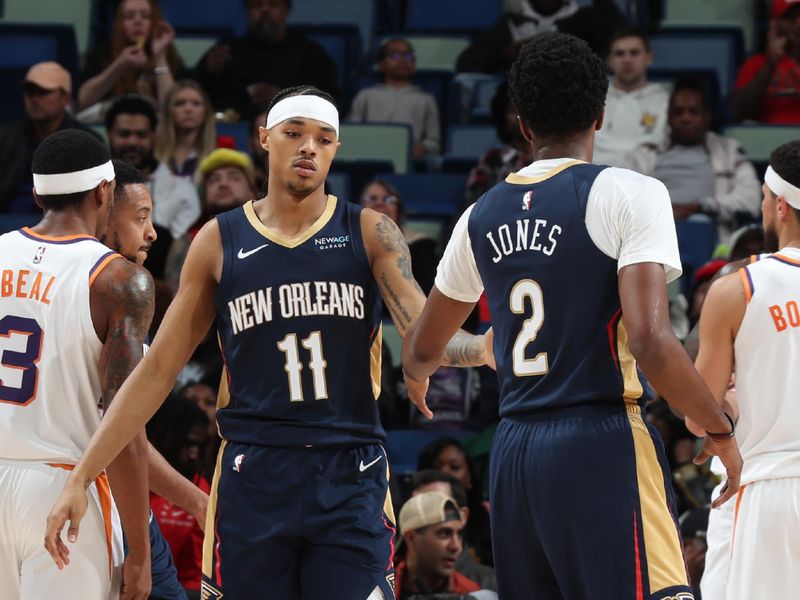 NEW ORLEANS, LA - DECEMBER 5: Jalen Crutcher #11 and Herbert Jones #2 of the New Orleans Pelicans high five during the game against the Phoenix Suns on December 5, 2024 at the Smoothie King Center in New Orleans, Louisiana. NOTE TO USER: User expressly acknowledges and agrees that, by downloading and or using this Photograph, user is consenting to the terms and conditions of the Getty Images License Agreement. Mandatory Copyright Notice: Copyright 2024 NBAE (Photo by Layne Murdoch Jr./NBAE via Getty Images)