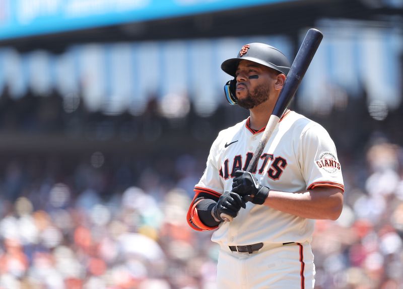 Jun 5, 2025; San Francisco, California, USA; San Francisco Giants first baseman Dominic Smith (7) at bat against the San Diego Padres during the second inning at Oracle Park. Mandatory Credit: Kelley L Cox-Imagn Images