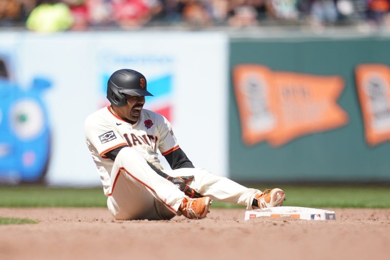 May 27, 2024; San Francisco, California, USA; San Francisco Giants first baseman LaMonte Wade Jr. (31) reacts after suffering an injury after hitting a double against the Philadelphia Phillies in the fifth inning at Oracle Park. Mandatory Credit: Cary Edmondson-USA TODAY Sports