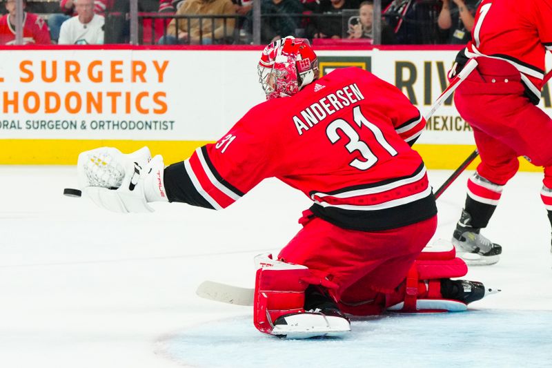 Oct 26, 2023; Raleigh, North Carolina, USA; Carolina Hurricanes goaltender Frederik Andersen (31) reaches out to make glove save against the Seattle Kraken during the second period at PNC Arena. Mandatory Credit: James Guillory-USA TODAY Sports