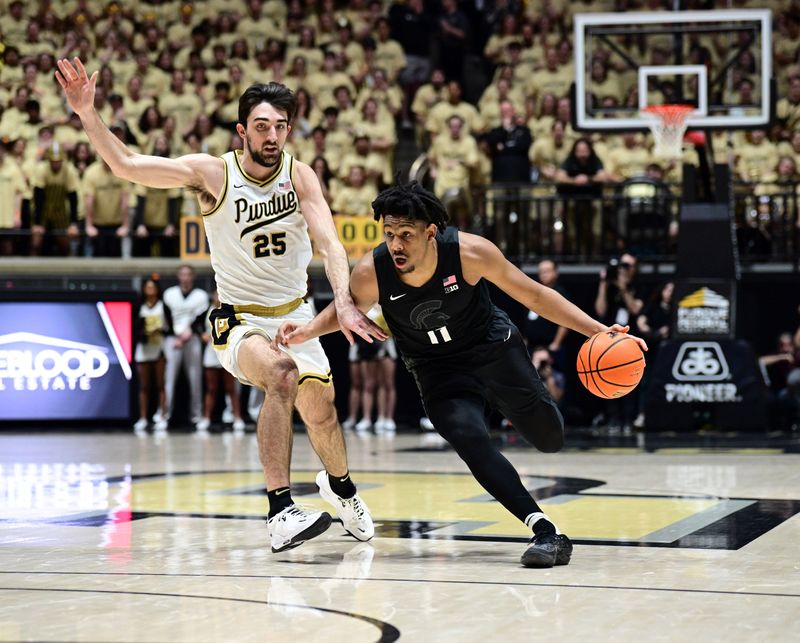 Mar 2, 2024; West Lafayette, Indiana, USA; Michigan State Spartans guard A.J. Hoggard (11) derives the ball around Purdue Boilermakers guard Ethan Morton (25) during the first half at Mackey Arena. Mandatory Credit: Marc Lebryk-USA TODAY Sports