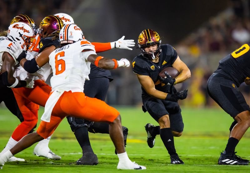 Sep 9, 2023; Tempe, Arizona, USA; Arizona State Sun Devils running back Cameron Skattebo (4) against the Oklahoma State Cowboys in the first half at Mountain America Stadium. Mandatory Credit: Mark J. Rebilas-USA TODAY Sports