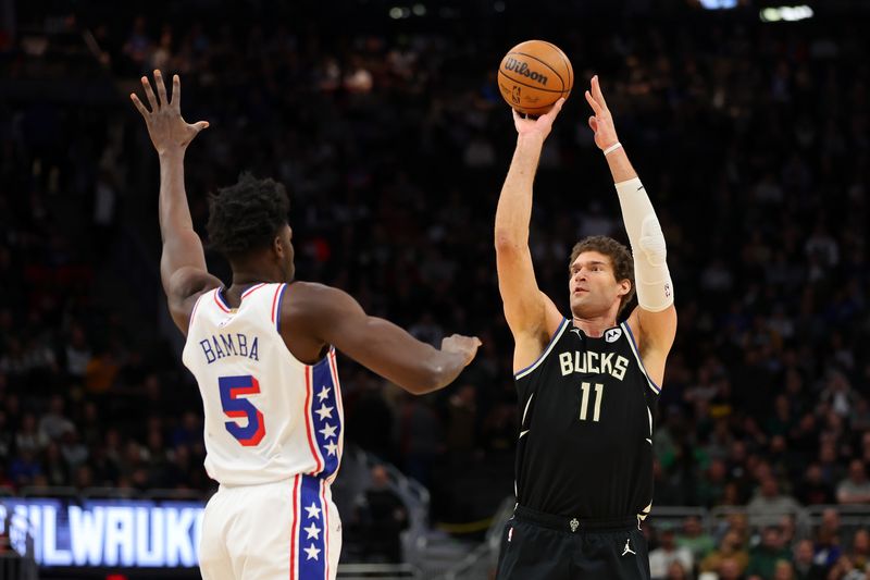 MILWAUKEE, WISCONSIN - MARCH 14: Brook Lopez #11 of the Milwaukee Bucks shoots over Mo Bamba #5 of the Philadelphia 76ers during the first half of a game at Fiserv Forum on March 14, 2024 in Milwaukee, Wisconsin. NOTE TO USER: User expressly acknowledges and agrees that, by downloading and or using this photograph, User is consenting to the terms and conditions of the Getty Images License Agreement. (Photo by Stacy Revere/Getty Images)