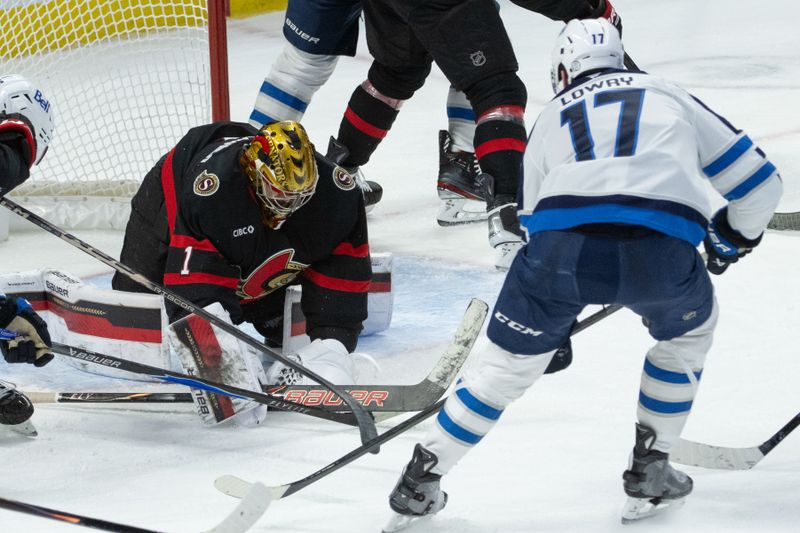 Jan 3, 2026; Ottawa, Ontario, CAN; Ottawa Senators goalie Leevi Merilainen (1) covers the puck in front of Winnipeg Jets center Adam Lowry (17) in the third period at the Canadian Tire Centre. Mandatory Credit: Marc DesRosiers-IMAGN Images