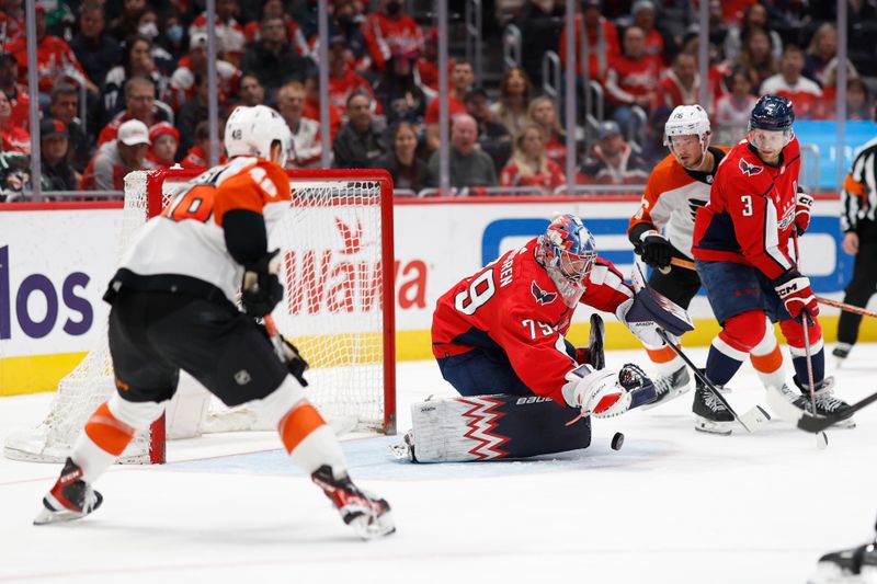 Mar 1, 2024; Washington, District of Columbia, USA; Washington Capitals goaltender Charlie Lindgren (79) covers the pub in front of Philadelphia Flyers center Morgan Frost (48) in the second period at Capital One Arena. Mandatory Credit: Geoff Burke-USA TODAY Sports