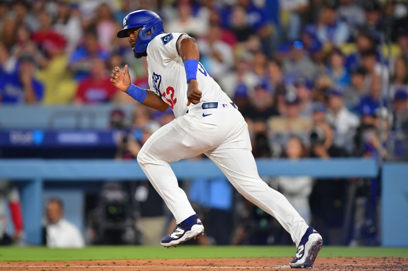 Sep 15, 2025; Los Angeles, California, USA; Los Angeles Dodgers catcher Chuckie Robinson (52) runs toward first base after a bunt against the Philadelphia Phillies in the third inning at Dodger Stadium. Mandatory Credit: Gary A. Vasquez-Imagn Images