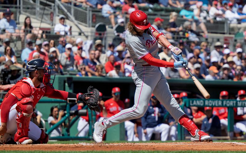 Mar 11, 2025; Fort Myers, Florida, USA; Phillies Alec Bohm (28) connects with the ball for the out on a sacrifice fly to right field during their game with the Boston Rex at JetBlue Park at Fenway South. Mandatory Credit: Chris Tilley-Imagn Images