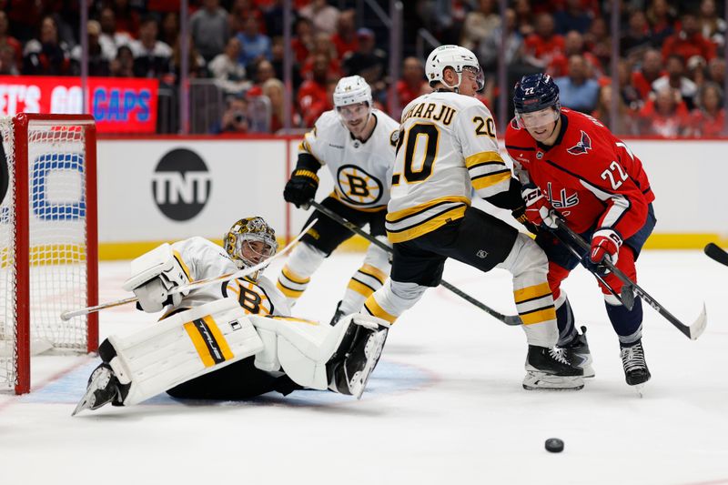Oct 8, 2025; Washington, District of Columbia, USA; Boston Bruins defenseman Henri Jokiharju (20) and Washington Capitals right wing Brandon Duhaime (22) battle for the puck in front of Bruins goaltender Jeremy Swayman (1) during the third period at Capital One Arena. Mandatory Credit: Geoff Burke-Imagn Images