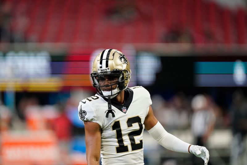 New Orleans Saints wide receiver Chris Olave (12) warms up before the first half of an NFL football game between the Atlanta Falcons and the New Orleans Saints, Sunday, Sept. 11, 2022, in Atlanta. (AP Photo/Brynn Anderson)