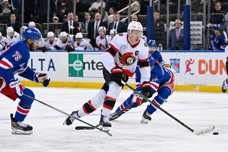 Jan 21, 2025; New York, New York, USA;  Ottawa Senators left wing Brady Tkachuk (7) skates between New York Rangers defenseman K'Andre Miller (79) and New York Rangers center Vincent Trocheck (16) during the third period at Madison Square Garden. Mandatory Credit: Dennis Schneidler-Imagn Images