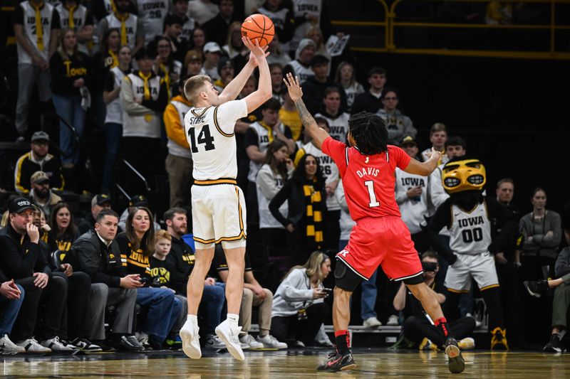 Jan 20, 2026; Iowa City, Iowa, USA; Iowa Hawkeyes guard Bennett Stirtz (14) shoots the ball over Rutgers Scarlet Knights guard Jamichael Davis (1) during the first half at Carver-Hawkeye Arena. Mandatory Credit: Jeffrey Becker-Imagn Images