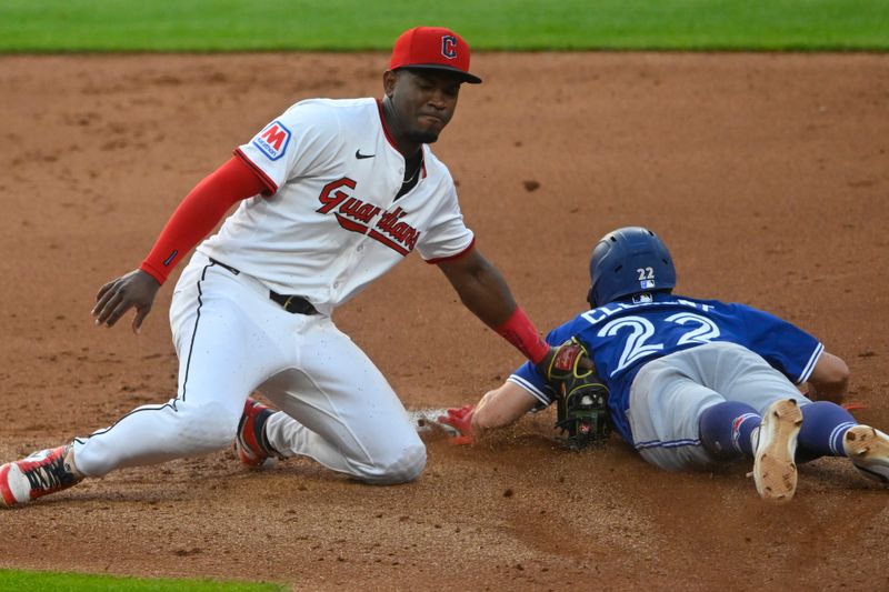 Jun 24, 2025; Cleveland, Ohio, USA; Toronto Blue Jays third baseman Ernie Clement (22) steals second base beside Cleveland Guardians second baseman Angel Martinez (1) in the fifth inning at Progressive Field. Mandatory Credit: David Richard-Imagn Images