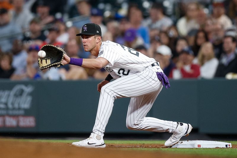 May 26, 2023; Denver, Colorado, USA; Colorado Rockies first baseman Nolan Jones (22) fields a throw at first for an out in the seventh inning against the New York Mets at Coors Field. Mandatory Credit: Isaiah J. Downing-USA TODAY Sports