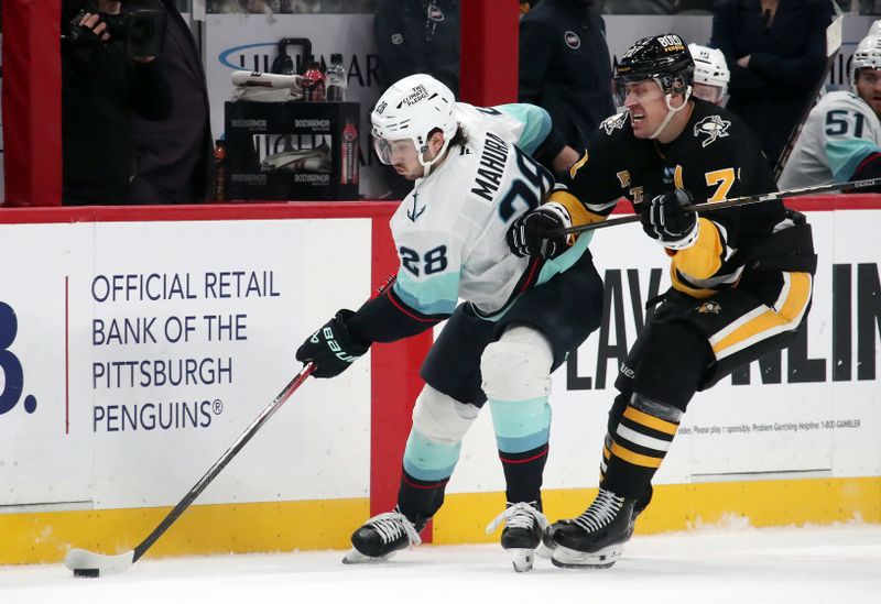 Jan 14, 2025; Pittsburgh, Pennsylvania, USA;  Seattle Kraken defenseman Joshua Mahura (28) moves the puck against Pittsburgh Penguins center Evgeni Malkin (71) during the third period at PPG Paints Arena. Mandatory Credit: Charles LeClaire-Imagn Images