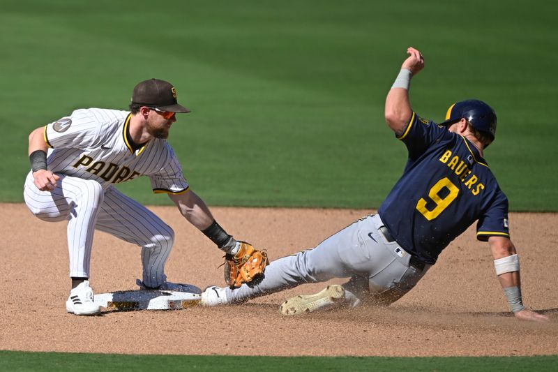 Sep 24, 2025; San Diego, California, USA; Milwaukee Brewers left fielder Jake Bauers (9) is tagged out by San Diego Padres second baseman Jake Cronenworth (9) as he tries to steal second base during the sixth inning at Petco Park. Mandatory Credit: Denis Poroy-Imagn Images